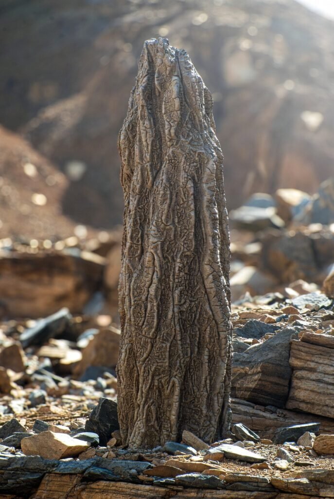 A detailed reconstruction of a Prototaxites organism towering amidst an ancient Silurian landscape.