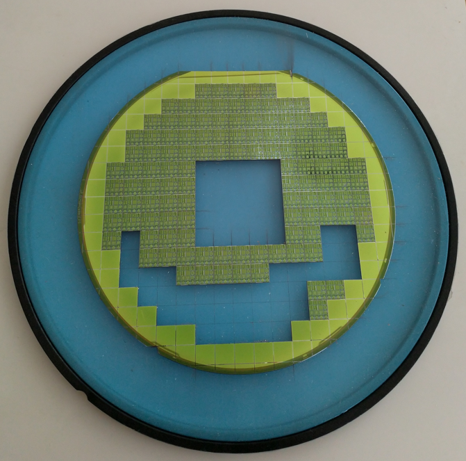 A semiconductor wafer on dicing tape with chips removed